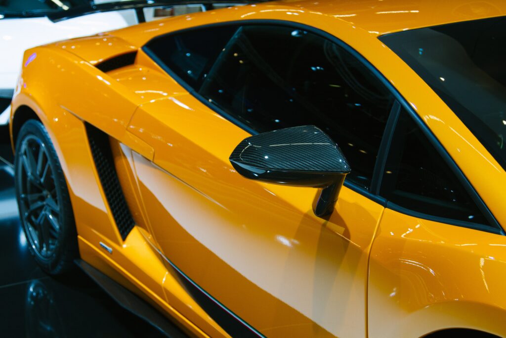 Sleek Orange Supercar Wallpaper - Luxurious Side View Background