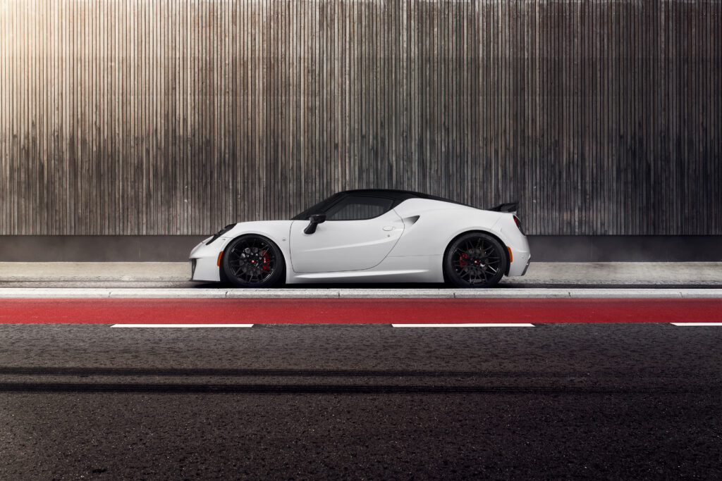 Sleek Pogea Racing Alfa Romeo 4C Wallpaper in Industrial Setting