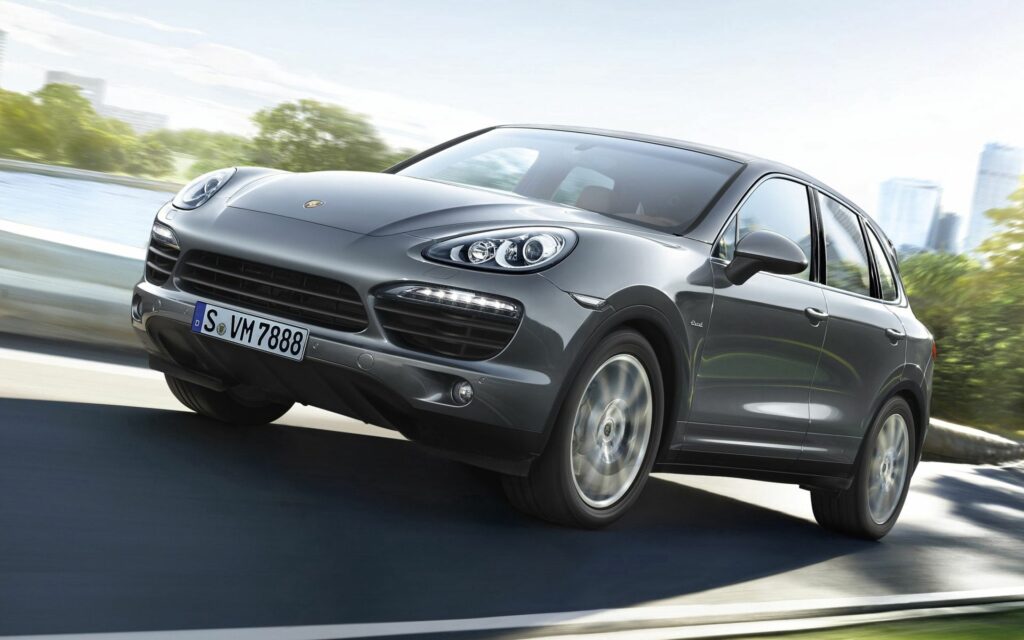Dynamic Porsche Cayenne S Wallpaper: Sleek SUV on Scenic Road