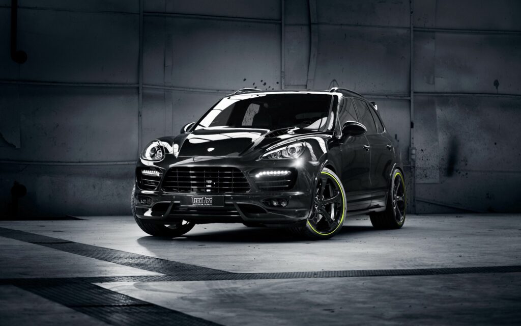 Sporty Porsche Cayenne with TechArt Tuning Over Industrial Backdrop Wallpaper