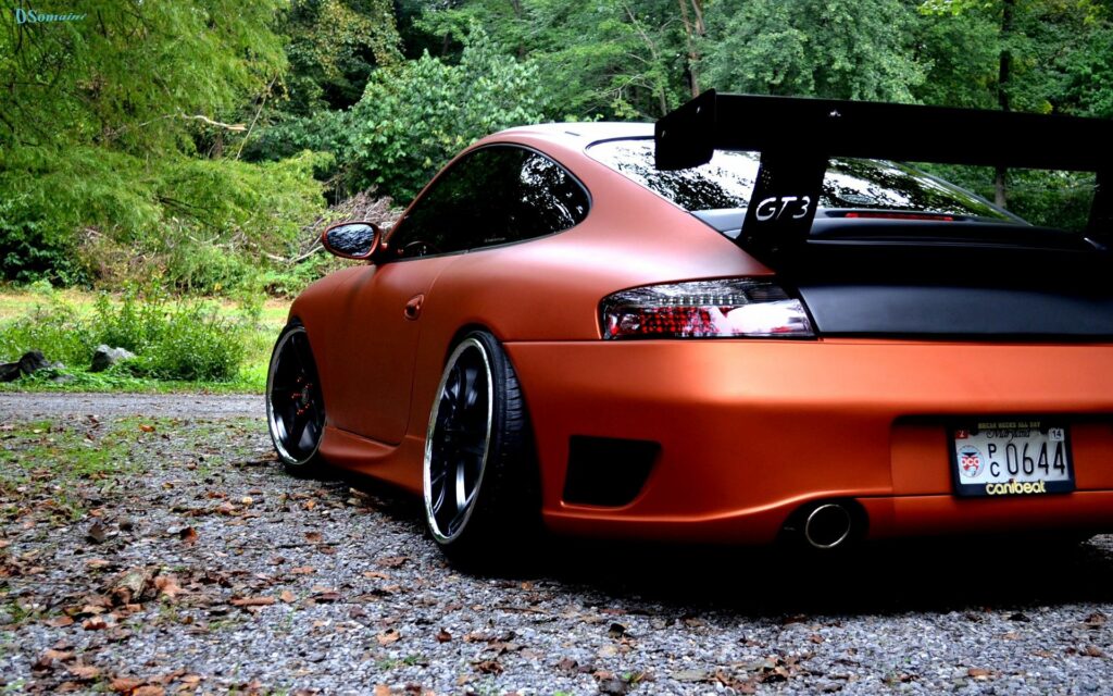 Stunning Matte Porsche Sports Car in Lush Greenery Background Wallpaper