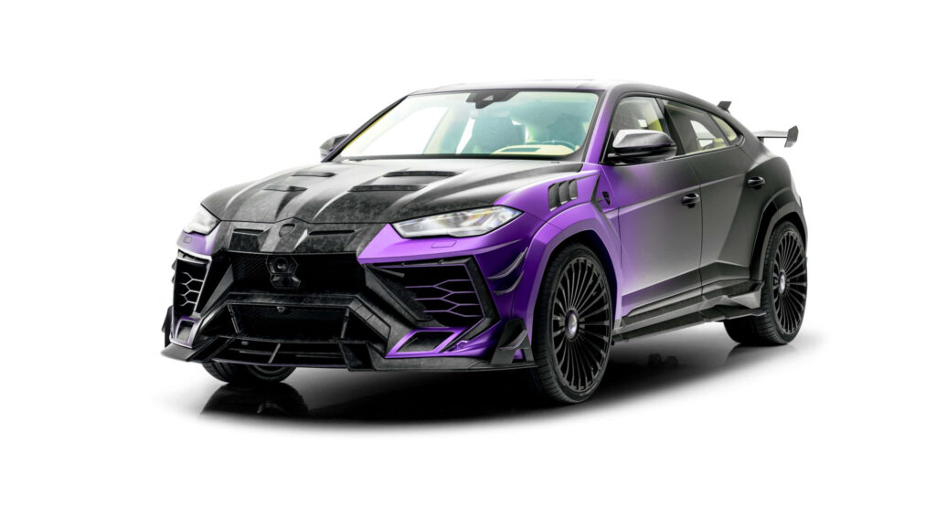 Sleek purple Lamborghini with aggressive styling receiving expert detailing on wallpaper background