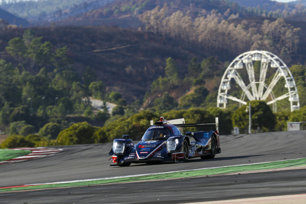 Dynamic Racing Car on Scenic Track: Speed and Thrill in Motorsports Wallpaper