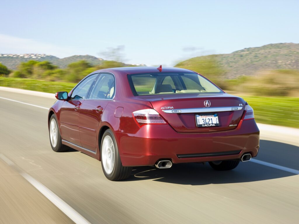 Sleek Red Acura RL Rear View Wallpaper with Scenic Background