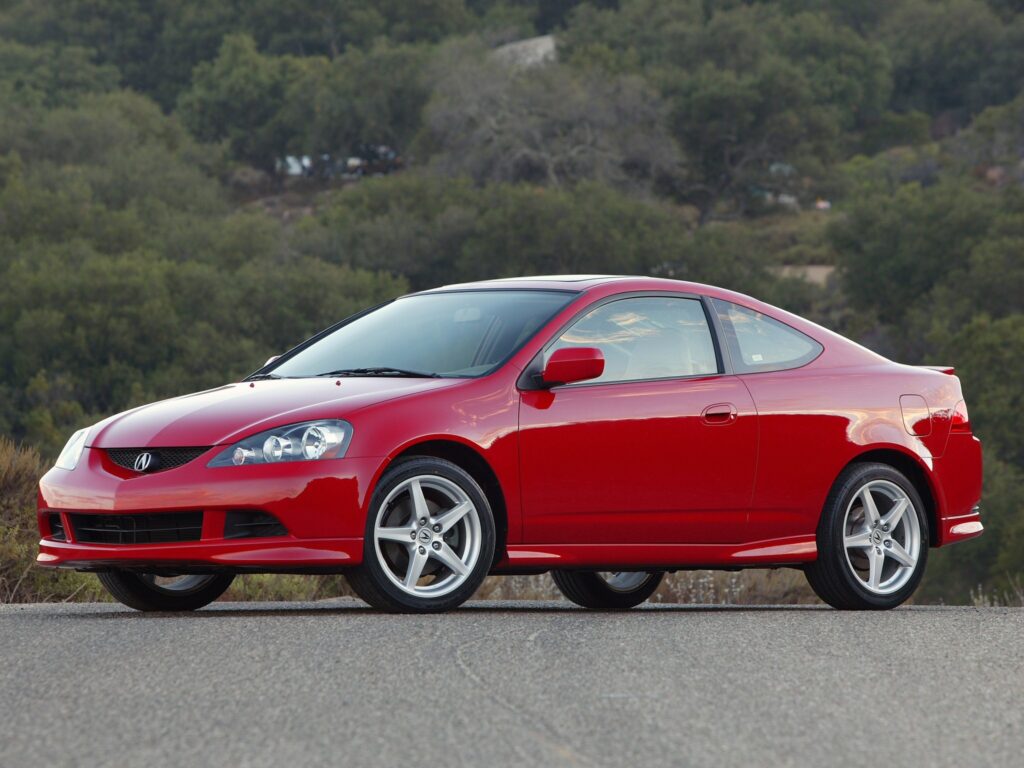 Stylish Red Acura RSX Against Lush Greenery - Side View Wallpaper