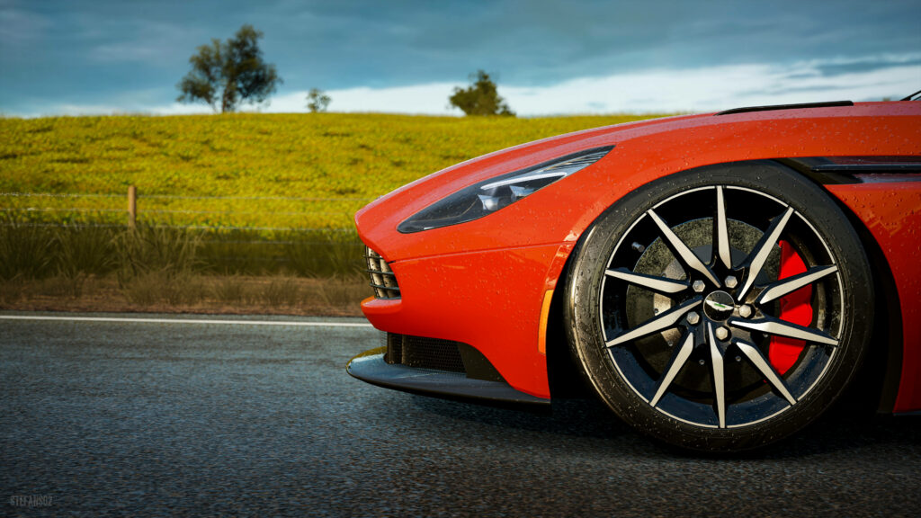 Elegant Red Aston Martin in Scenic Forza Horizon-Inspired Wallpaper
