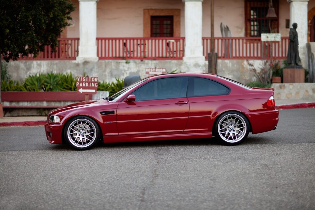 Stunning Red BMW E46 M3 Profile with Rustic Background Wallpaper
