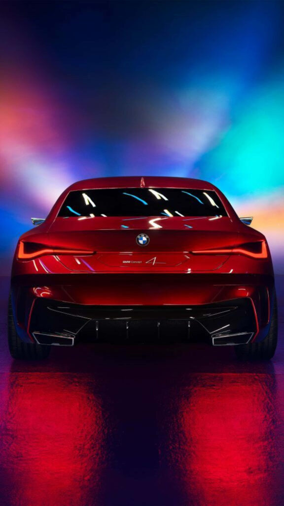 Rear view of sleek red BMW car with vibrant colorful illuminated background 4K wallpaper