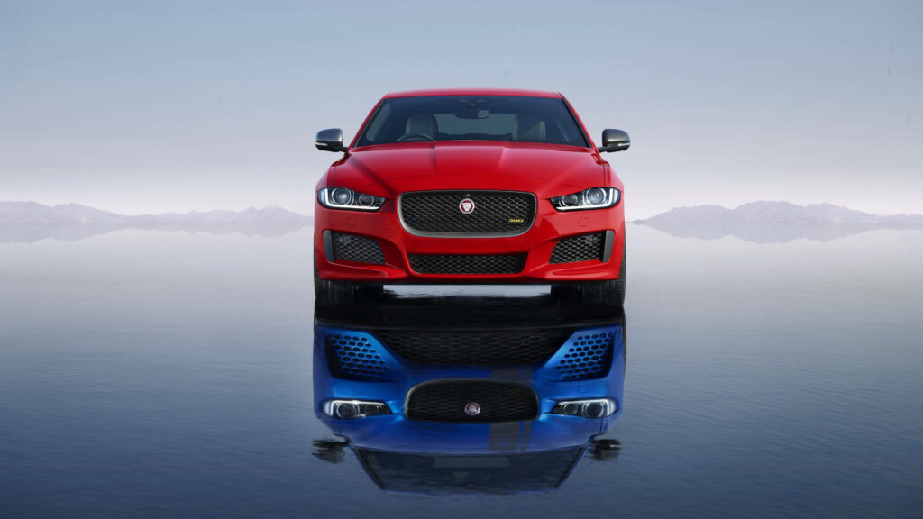 Sleek Red Car Wallpaper: Elegant Reflection with Mountain Background