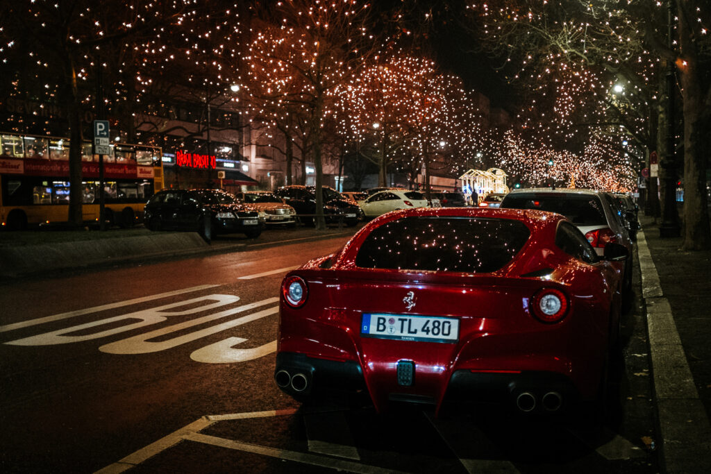 Vibrant Night City with Sleek Red Ferrari - 4210x2807 Wallpaper