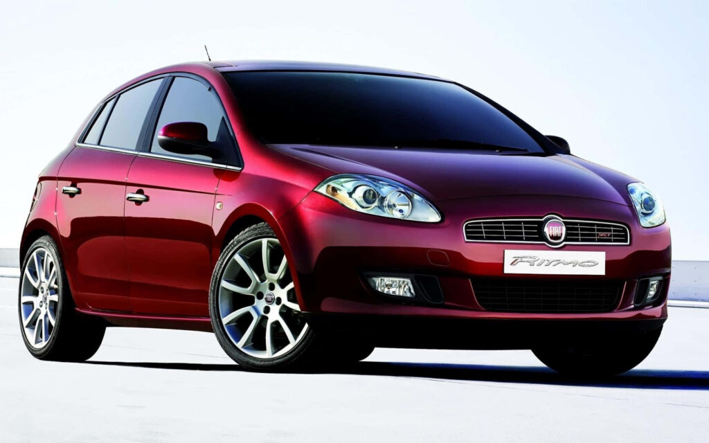 Stylish Red Fiat Bravo in Motion | Eye-Catching Automotive Wallpaper