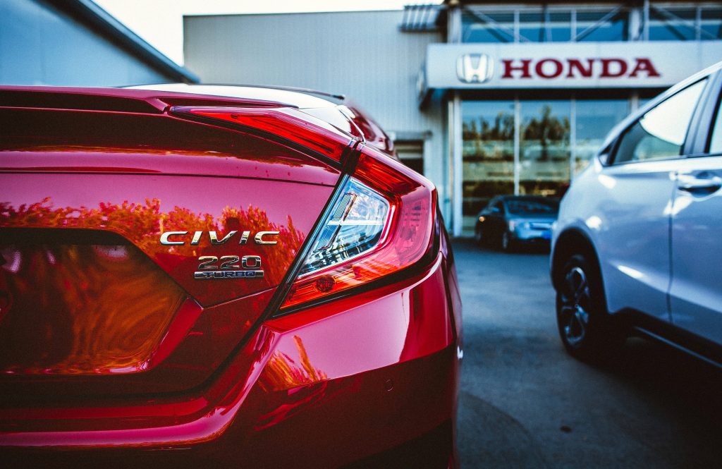 Red Honda Civic 220 Turbo rear taillight close-up at dealership modern sleek design wallpaper