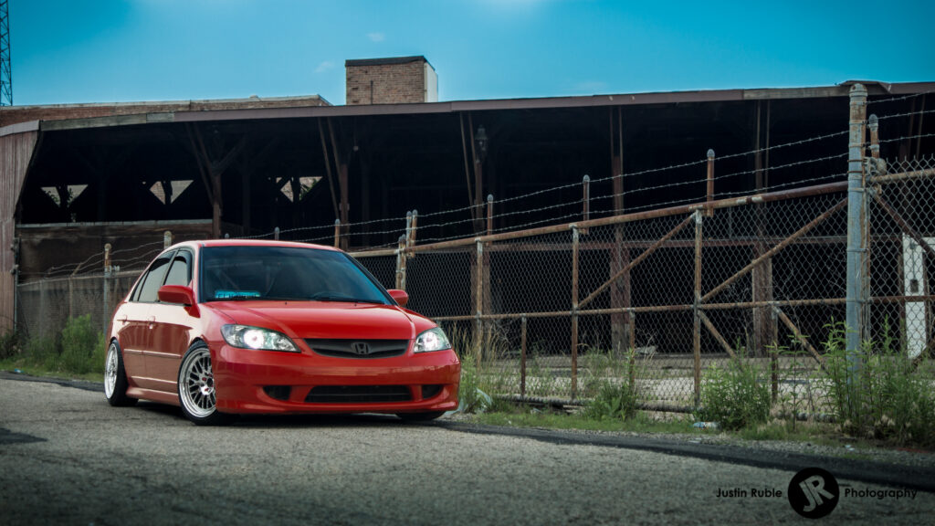 Sleek Red Honda Civic Wallpaper: Industrial Contrast Background