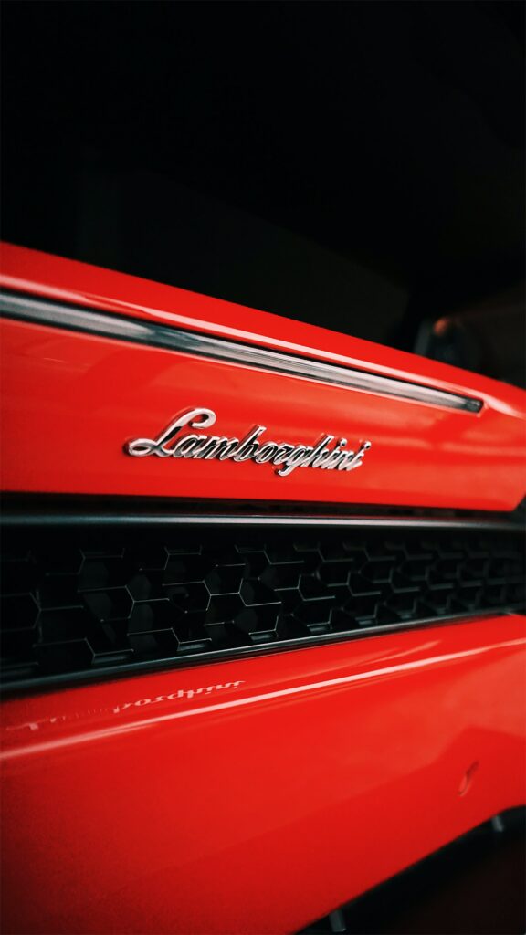 Red Lamborghini Front Grille: Luxury Wallpaper Background