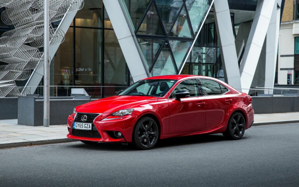 Sleek Red Lexus IS Wallpaper: Sporty Side View in Urban Setting