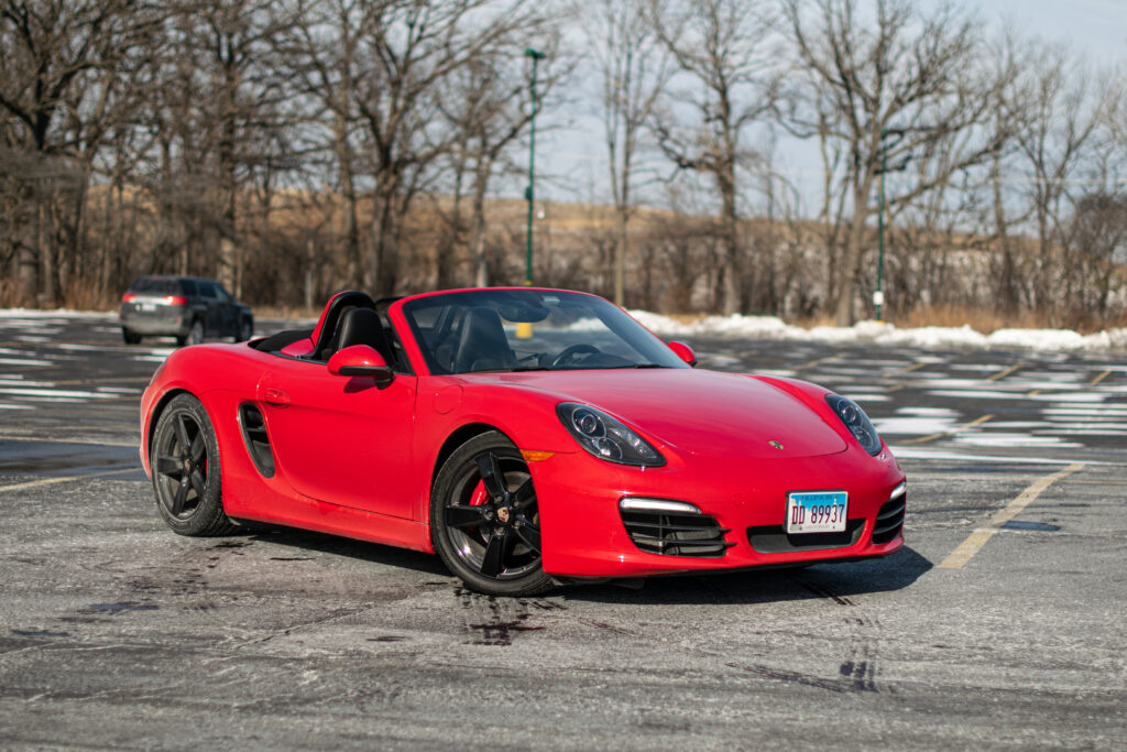 Vibrant Red Porsche Boxster S in Winter Landscape Wallpaper