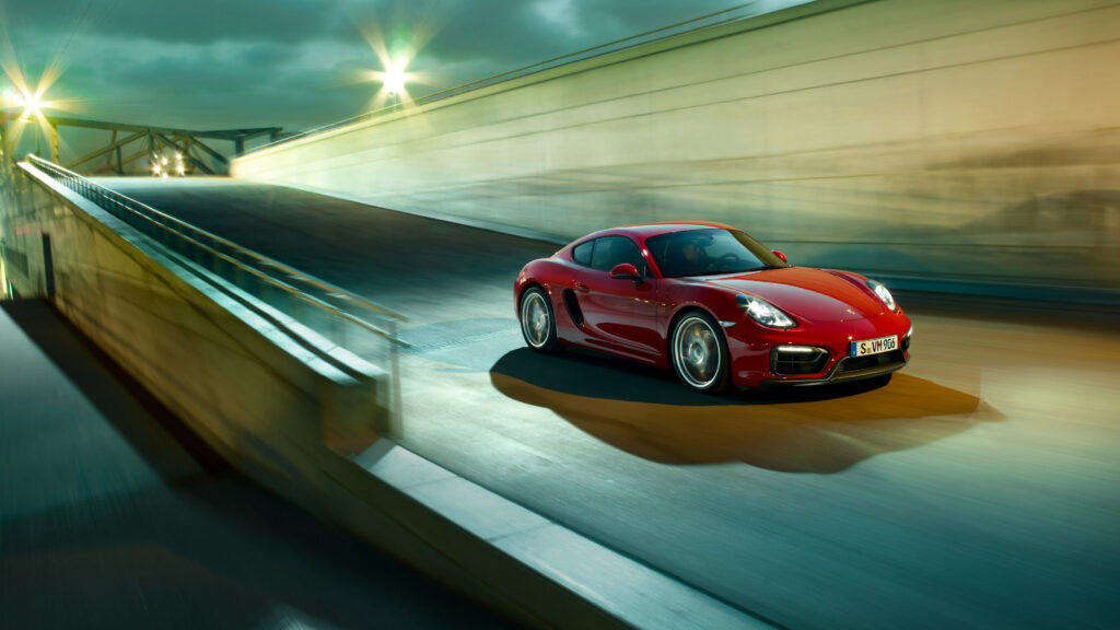 Sleek Red Porsche Cayman GTS in Urban Setting - Sporty Wallpaper
