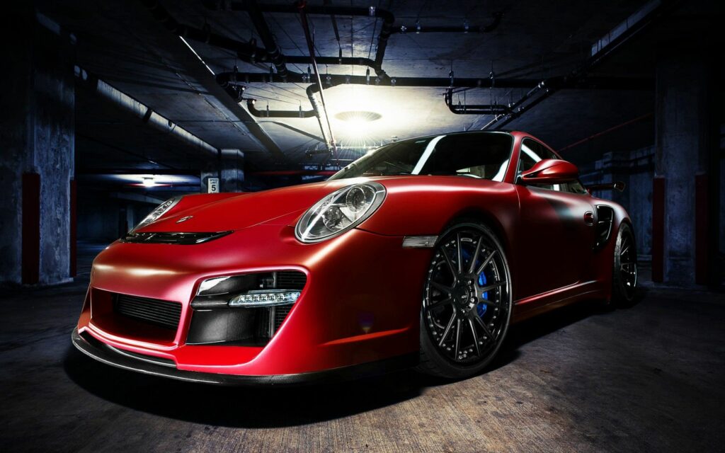 Sleek Red Porsche in Dimly Lit Underground Garage Wallpaper