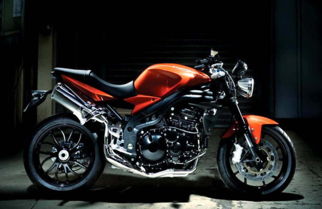 Red Sport Motorcycle Wallpaper: Sleek Design in Dim Garage Setting
