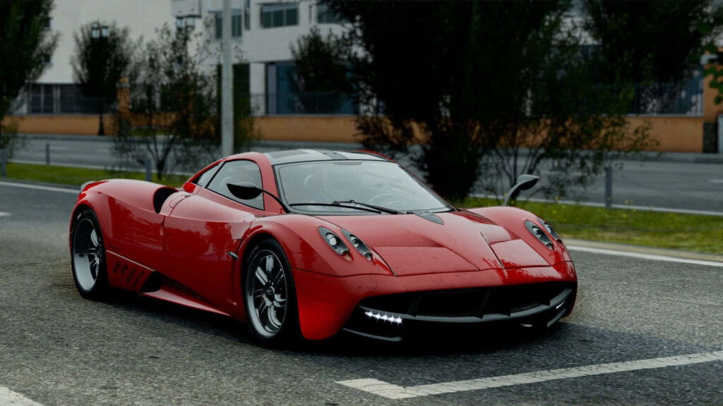Red sports car parked on urban street highlighting sleek design and powerful presence wallpaper