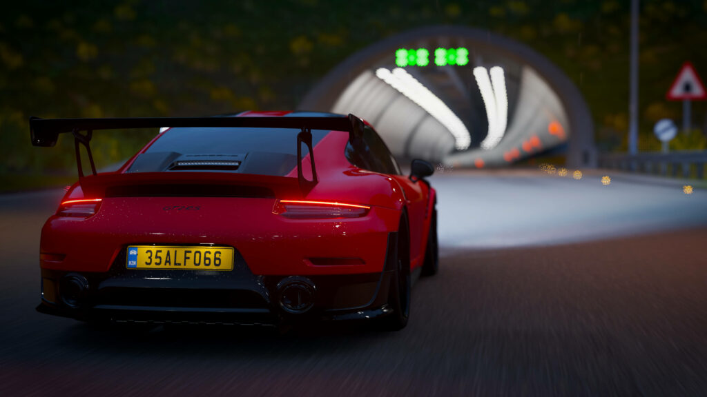 Red sports car racing into illuminated tunnel Forza 4 high speed driving wallpaper background