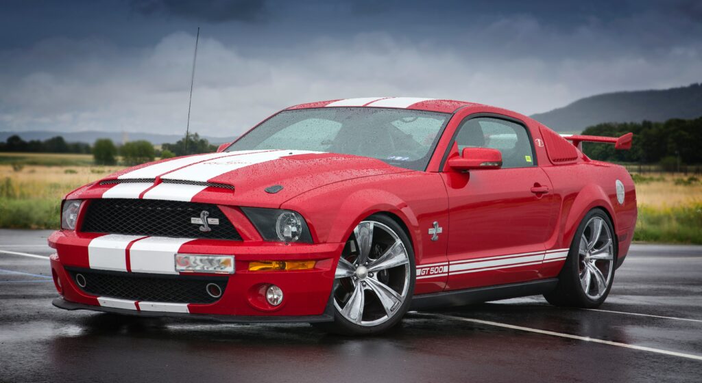 Sleek Red Sports Car Wallpaper with Dynamic Design and Moody Background