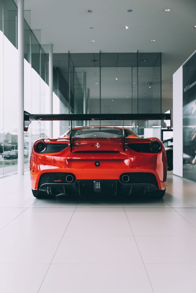Sleek Red Sports Car Wallpaper: Aerodynamic Design & Glossy Finish
