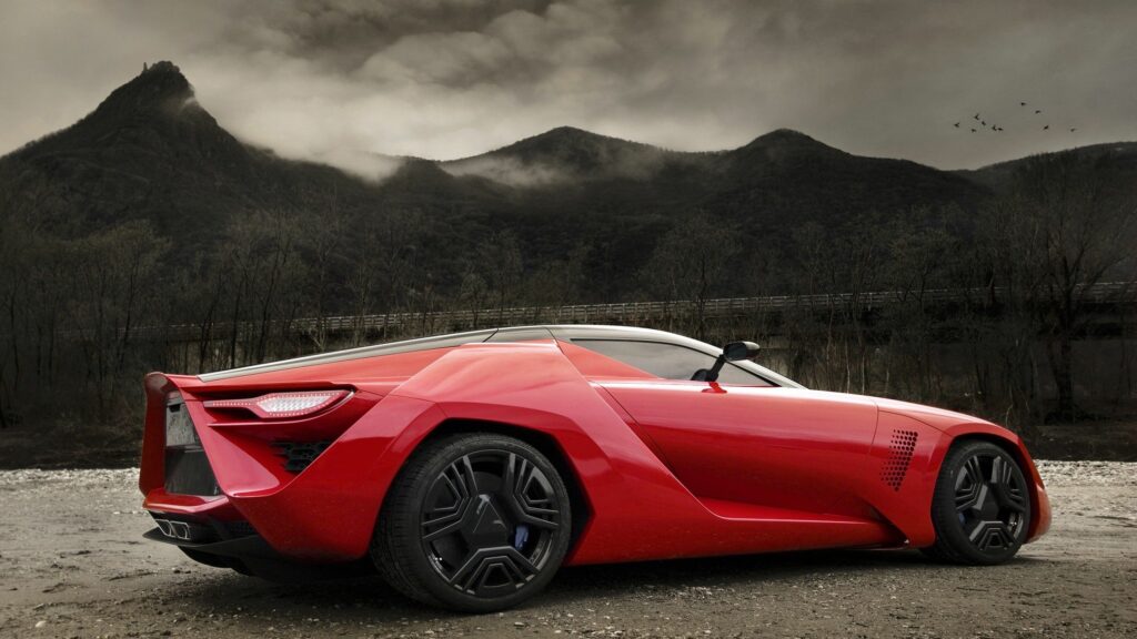Red Sports Car in Dramatic Mountainous Background - Wall Art Wallpaper