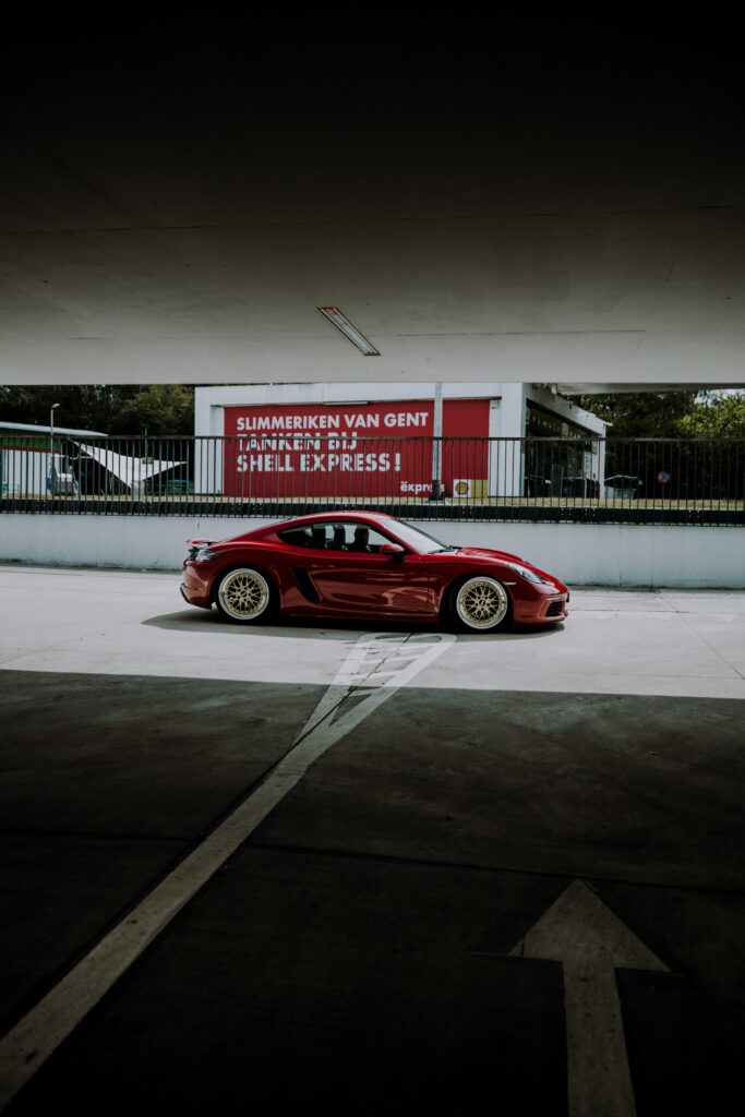 Sleek Red Sports Car Wallpaper - Side View in Urban Setting