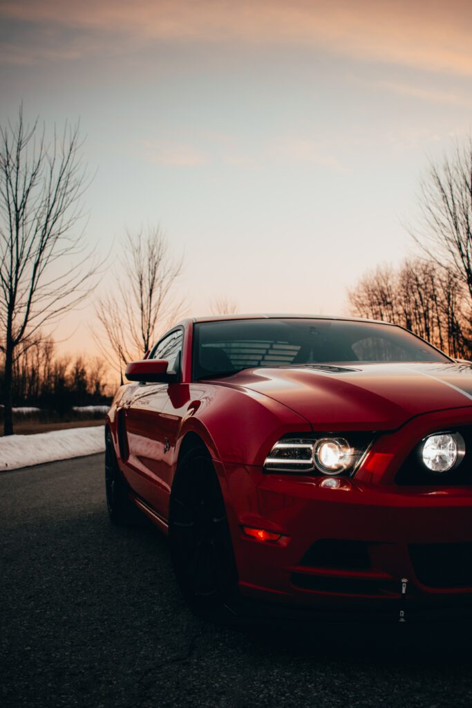 Sleek Red Sports Car at Sunset: Winter Evening Wallpaper