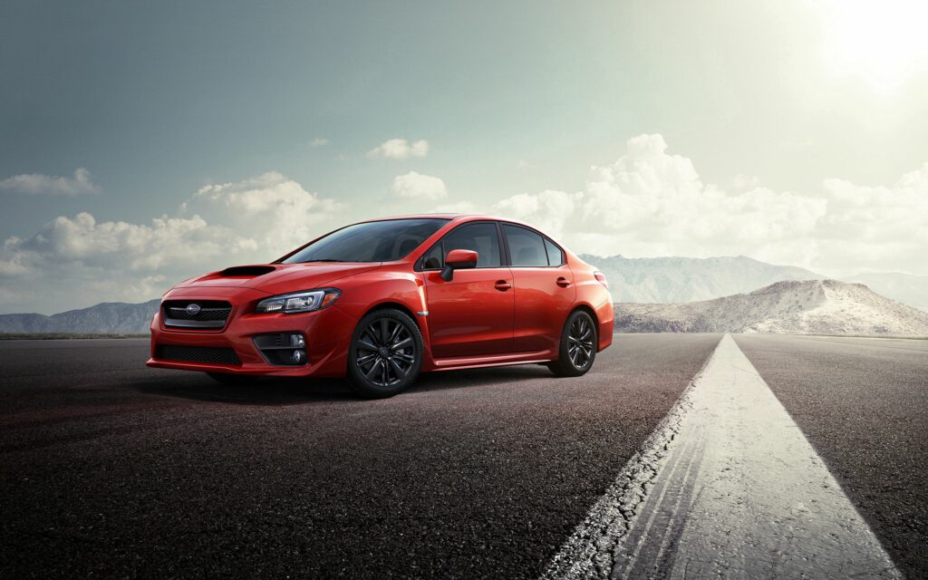 Sleek Red Subaru on Deserted Road - Adventure & Freedom Wallpaper