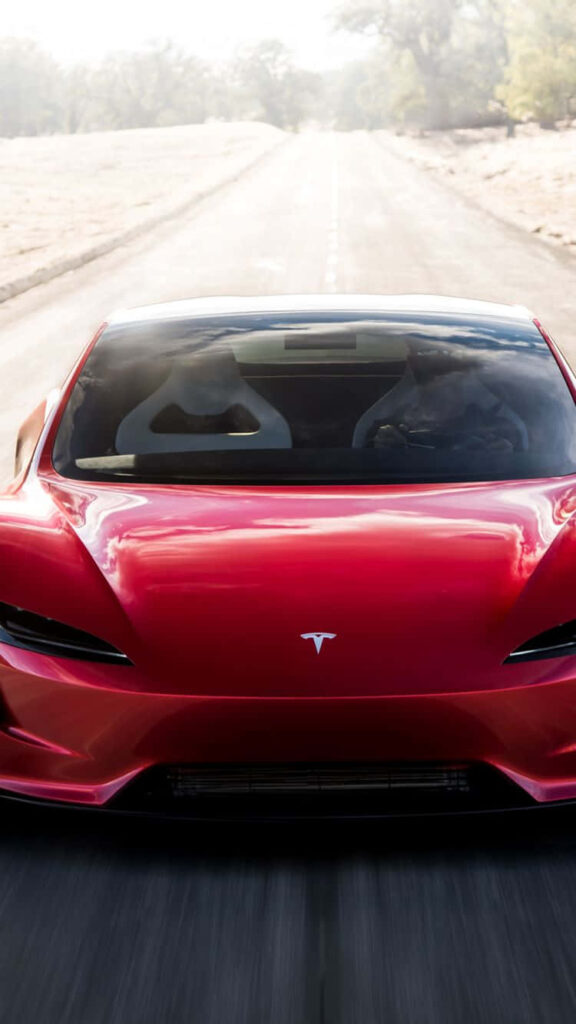 Red Tesla speeding on open road showcasing modern design high performance perfect wallpaper