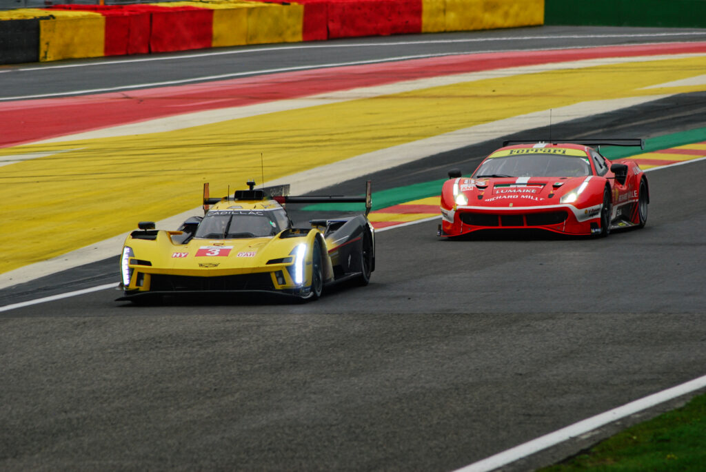 Intense Racetrack Duel: Red Bolide vs. Yellow Racing Car Wallpaper