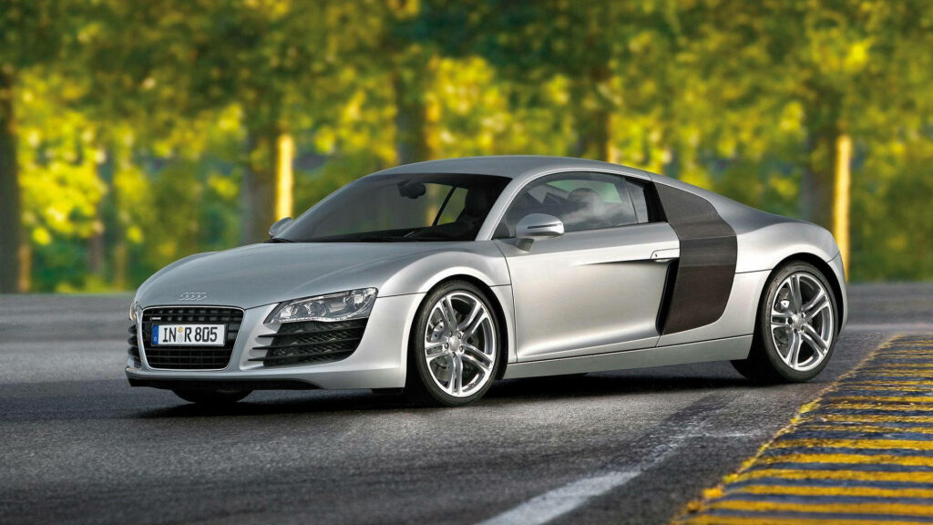 Silver Audi R8 parked on scenic road with blurred green forest full HD wallpaper background