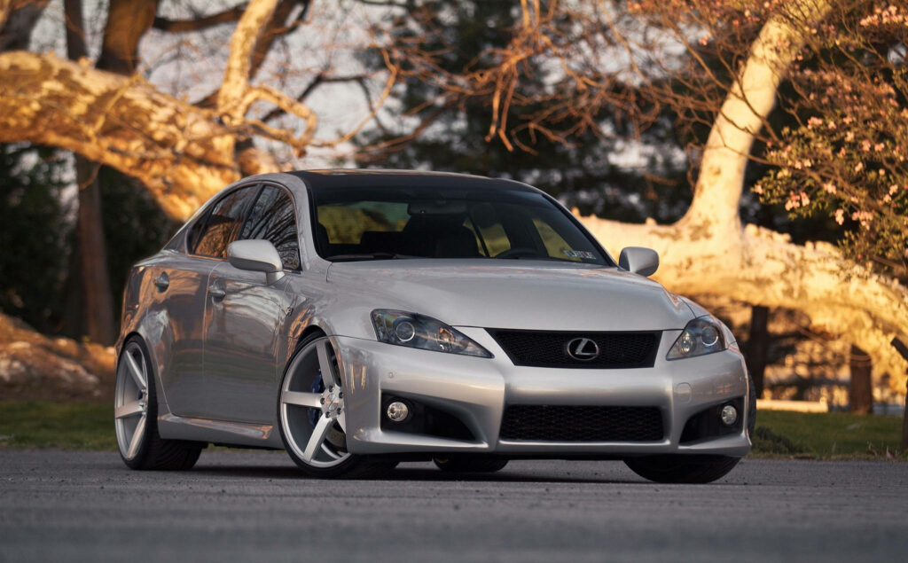 Sleek Silver Lexus IS 250 Wallpaper Amidst Natural Sunlit Setting