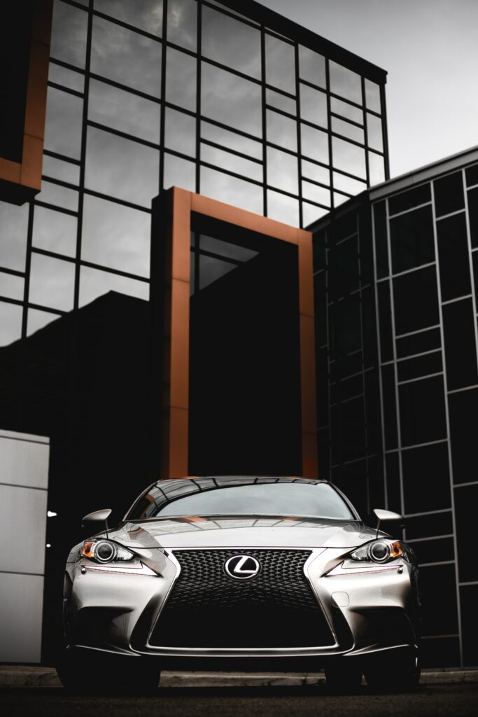 Sleek Silver Lexus RX: Luxury Design Against Modern Glass Architecture Wallpaper