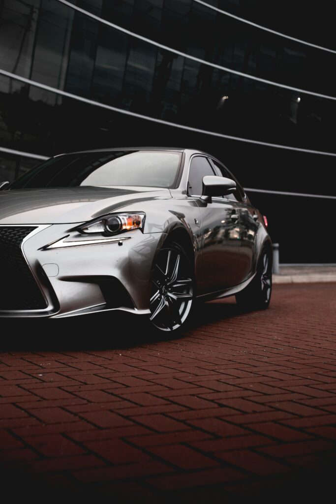 Sleek Silver Lexus RX on Brick with Modern Building Background Wallpaper