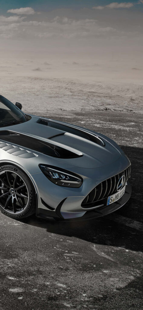 Silver Mercedes AMG with aggressive grille sporty design in dramatic outdoor wallpaper background