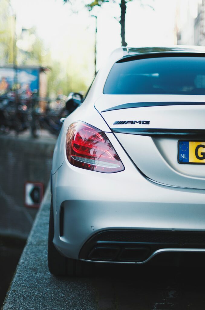 Sleek Silver Mercedes-Benz AMG Rear View in Urban Setting Wallpaper