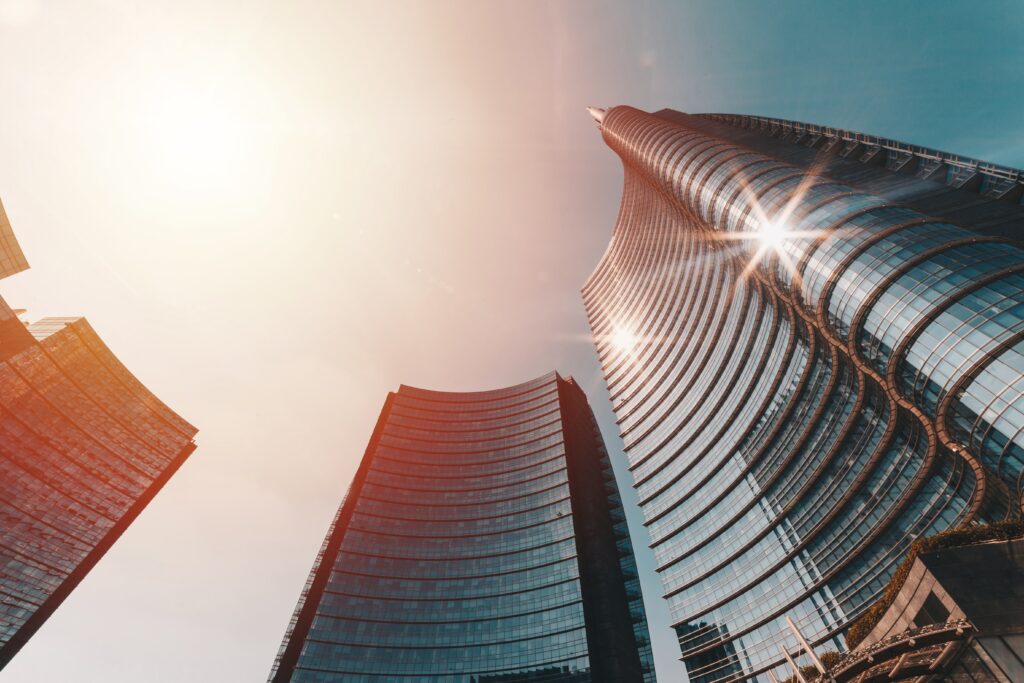 Stunning Modern Skyscraper Wallpaper: Bottom-Up View with Radiant Glow