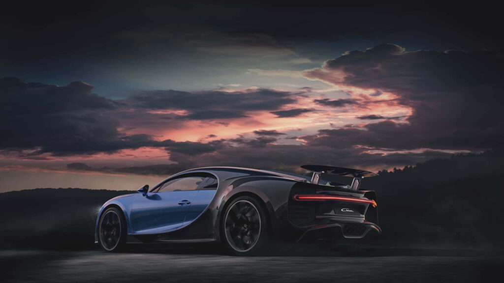 Sleek sports car with bold curves against a colorful dramatic evening sky 4K wallpaper background