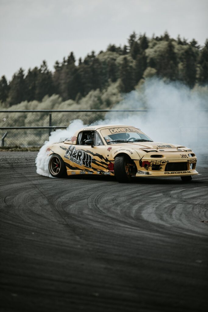 Dynamic Wallpaper: Sports Car Drifting on Racetrack Background