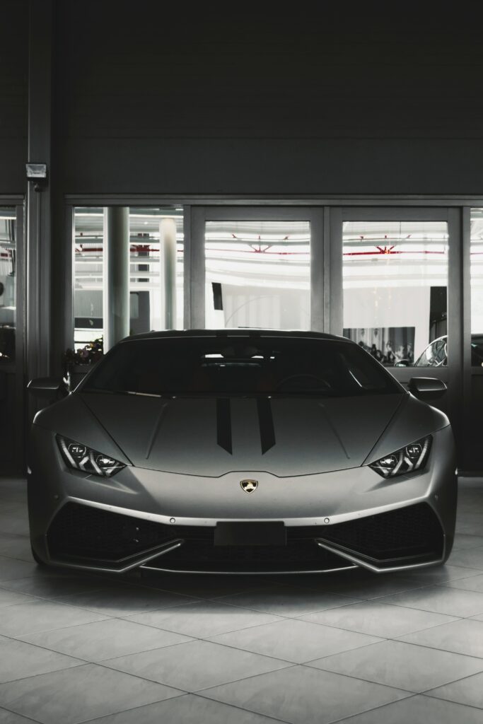 Sleek Sports Car in Garage: Dramatic Grayscale Wallpaper