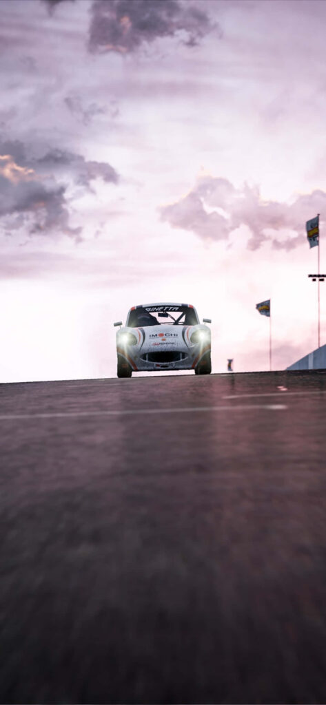 Sleek car speeding on race track at dusk with bright headlights under cloudy sky wallpaper background