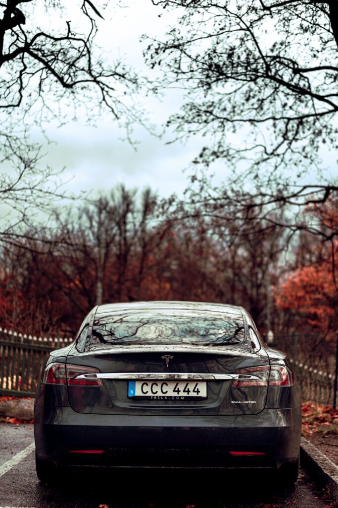 Sleek Sports Car Wallpaper: Elegant Rear View with Serene Background