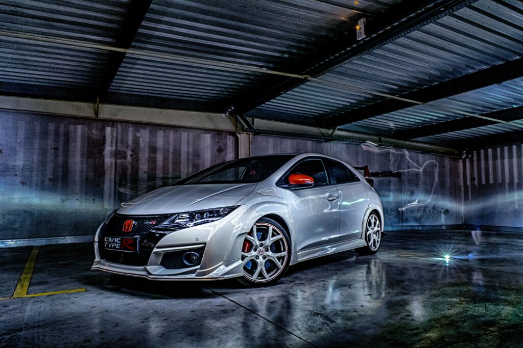 Sleek Sports Car Wallpaper in Dramatic Garage Setting - High-Res Image