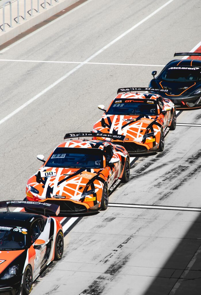 Sleek Sports Cars on Racetrack - Thrilling Wallpaper Background