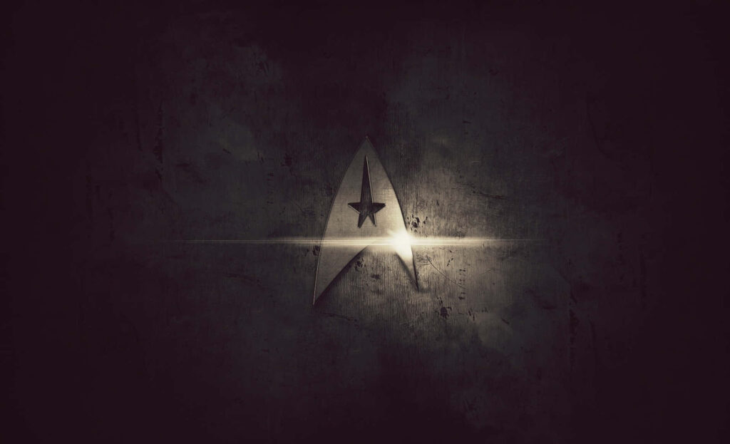 Star Trek Emblem Wallpaper: Illuminated Exploration Against Dark Texture