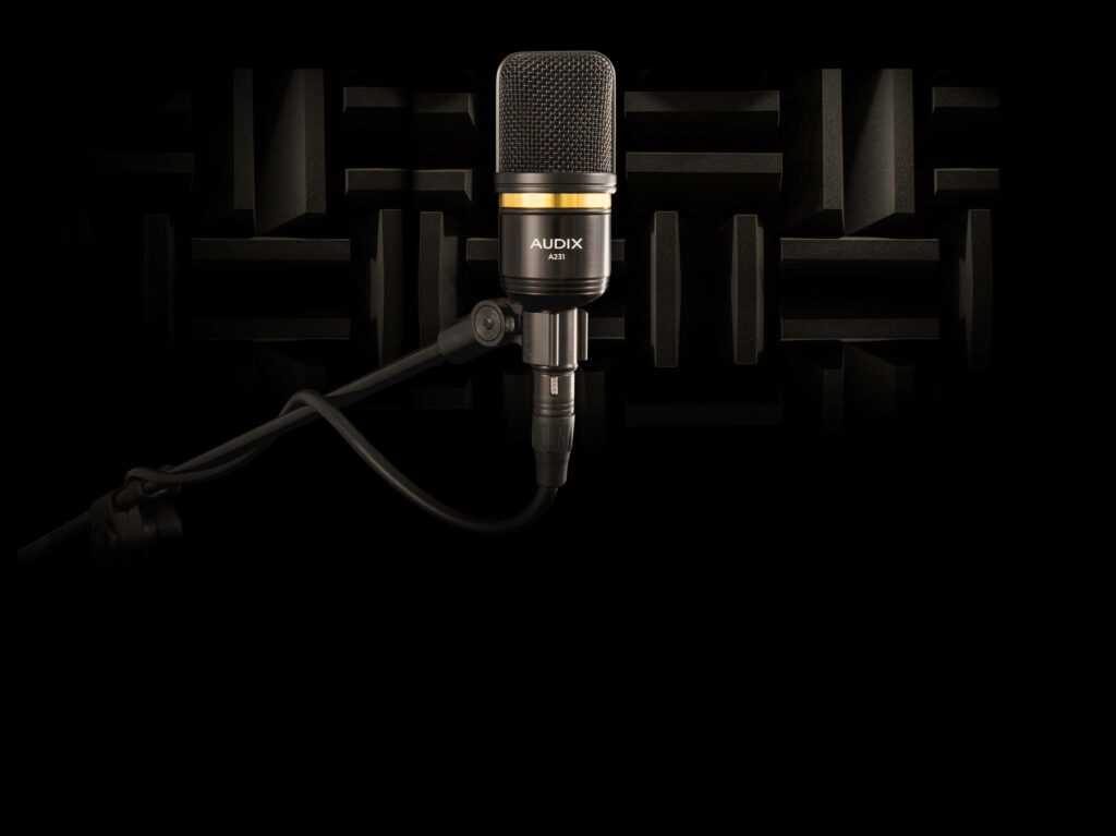Captivating Studio Microphone: A Masterful Portrait Against a Dramatic Canvas Wallpaper