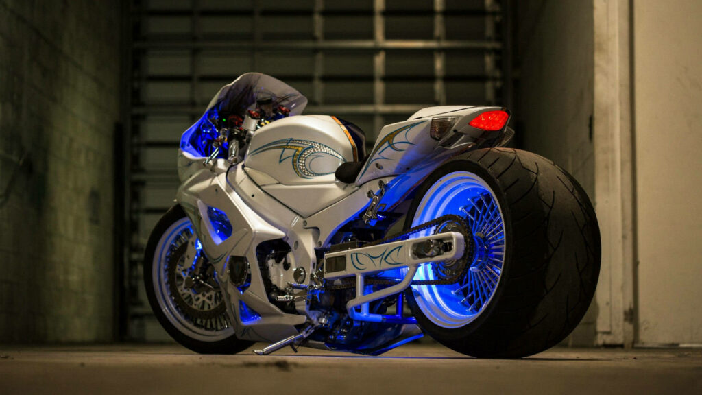 Sleek Suzuki Racing Motorcycle Wallpaper in Dim Garage with LED Lighting